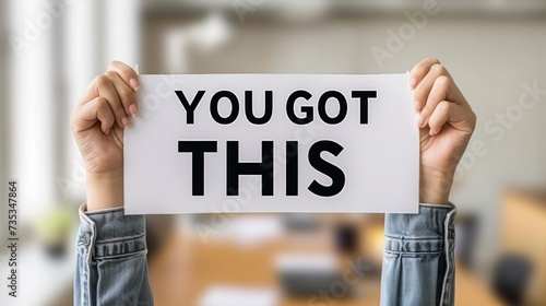 Motivational success concept  woman holding  you got this  sign on blurred background