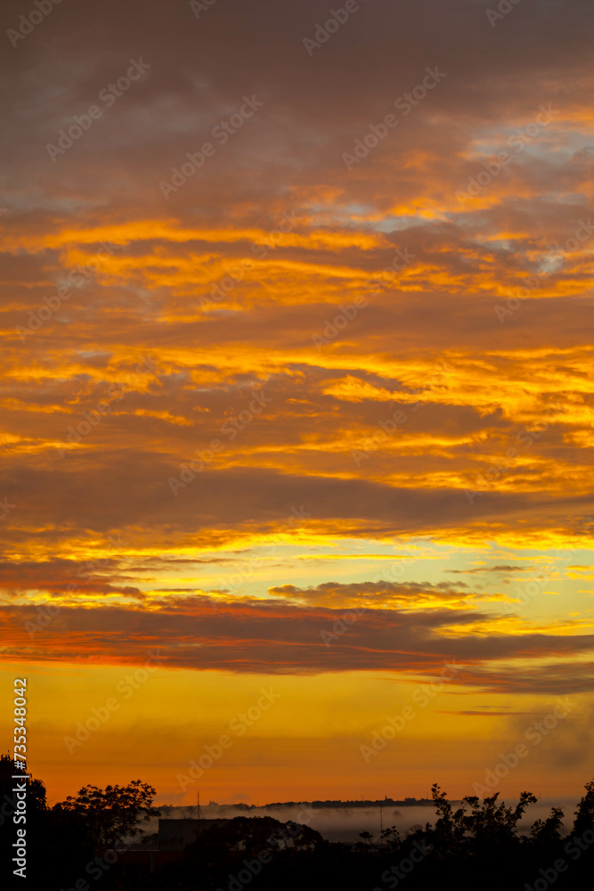 Beautiful idyllic sky at dawn with strong yellow and orange colors Beautiful idyllic sky at dawn with strong yellow and orange colors