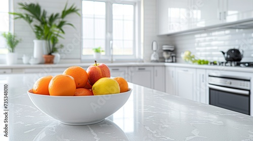 A bowl of citrus adds a pop of vibrant color and freshness in a light-toned modern kitchen. Inspiring fruit bowl in a contemporary setting. © Vagner Castro