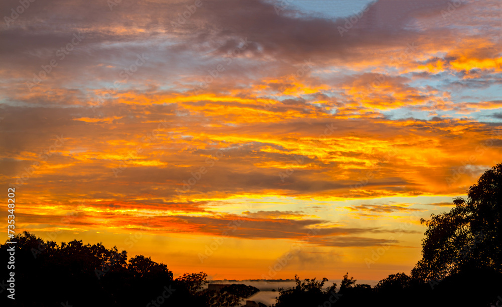 Beautiful idyllic sky at dawn with strong yellow and orange colors Beautiful idyllic sky at dawn with strong yellow and orange colors