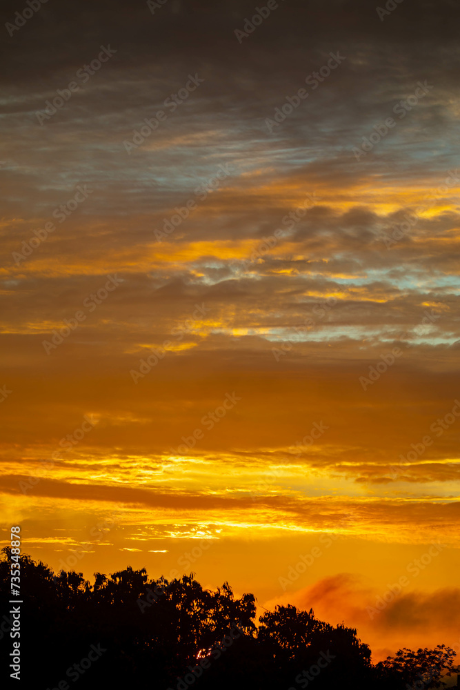 Beautiful idyllic sky at dawn with strong yellow and orange colors