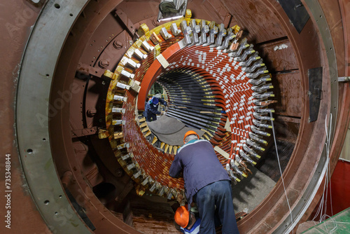 Fotografie Assembling stator winding in factory workshop.