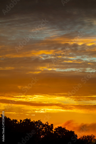 Beautiful idyllic sky at dawn with strong yellow and orange colors
