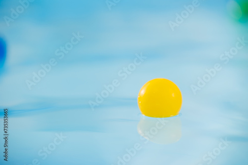 Children colored balls float in water for sports in pool © Parilov