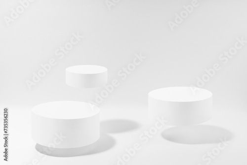 Three white round podiums in hard light levitate, set, mockup on white background. Template for presentation cosmetic products, gifts, goods, advertising, design, display, showing in modern style.