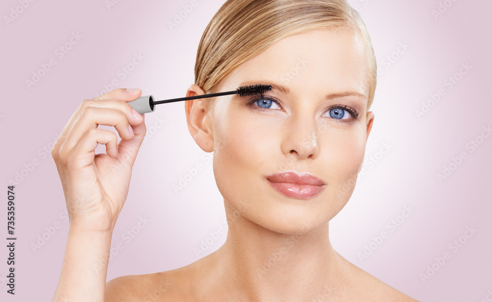 Beauty, mascara and portrait of girl in studio with confidence, makeup for lashes or facial glow. Glamour, cosmetics and face of woman on pink background with healthy skin shine, brush and wellness.