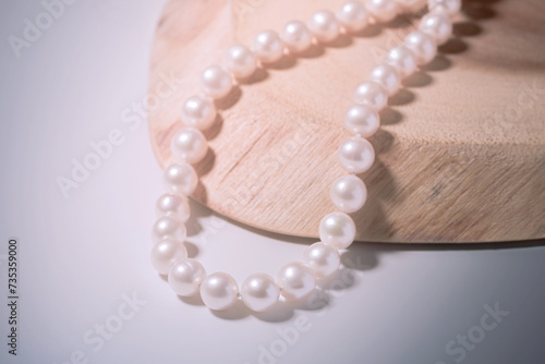 beautiful women's necklace made of natural white sea pearls on a light background