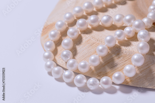 beautiful women's necklace made of natural white sea pearls on a light background