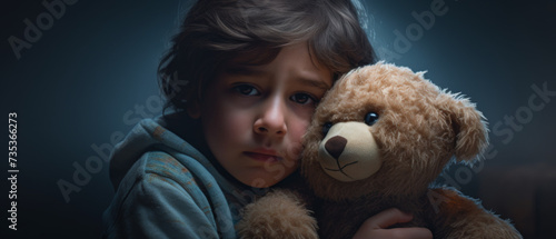Young Boy Clutching a Teddy Bear in a Darkened Room