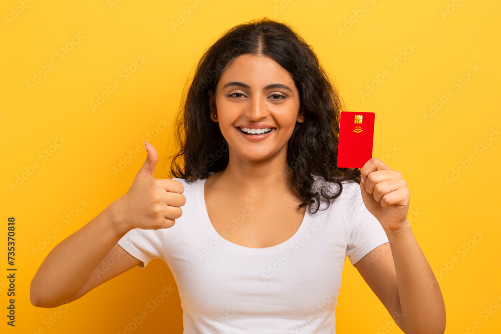 Closeup of smiling indian woman holding plastic debit credit card Closeup of smiling indian woman holding plastic debit credit card