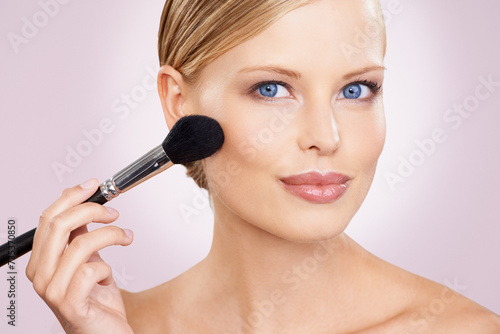 Cosmetics, brush and portrait of happy woman in studio with confidence, natural makeup or facial glow. Glamour, cosmetics and face of girl on pink background with healthy skin, smile or wellness.