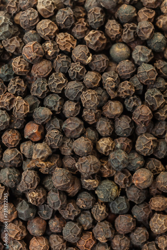 Dry black peppercorns background. Aromatic  organic spice. Top view.