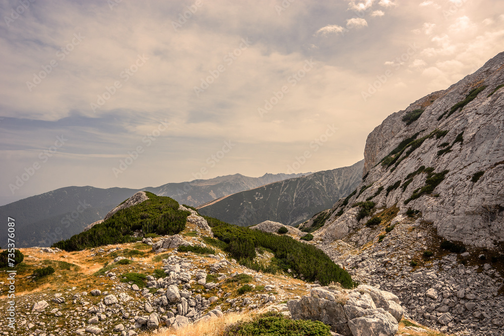 Fototapeta premium A route to Kazana shelter against Todorka peak in summer day. Pirin highlands near Vihren and Kutelo peaks in Pirin national park, Bulgaria.