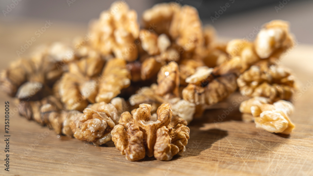 Peeled walnut kernels close-up on wooden background, Selective focus, tinted image. Peeled walnut kernels close-up on wooden background, Selective focus, tinted image.