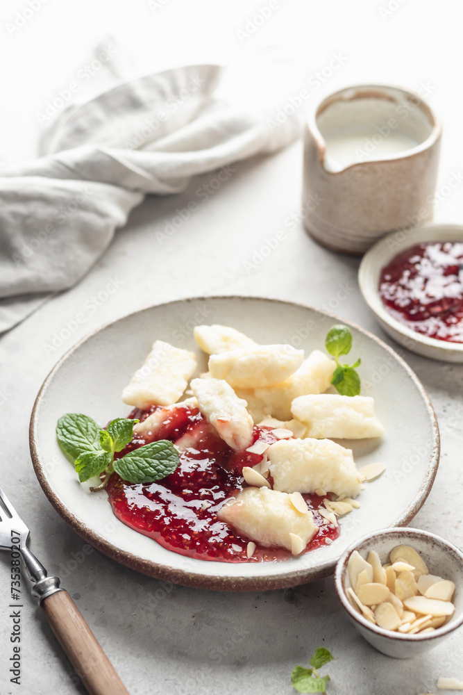 Lazy dumplings, vareniki with raspberry jam decorated with almond petals and mint leaves. Boiled cottage cheese homemade gnocchi Lazy dumplings, vareniki with raspberry jam decorated with almond petals and mint leaves. Boiled cottage cheese homemade gnocchi