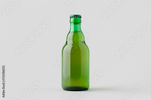 Green steinie beer bottle mockup on a grey background.