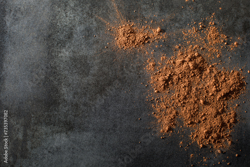 Cocoa powder on dark tile surface
