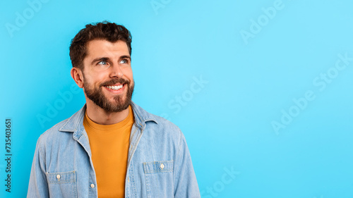Portrait of cheerful and confident guy looking aside with smile © Prostock-studio