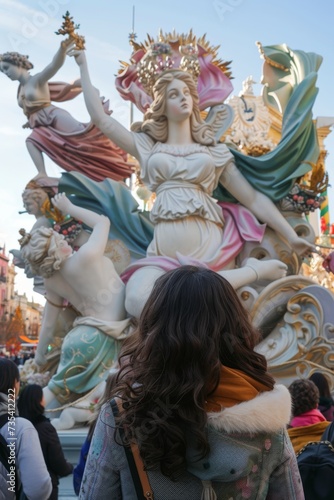 view from behind, a people view the impresionant monument of las fallas festivity in Valencia