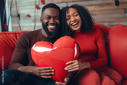 Man and Woman Sitting on Couch Holding Heart Shaped Pillow