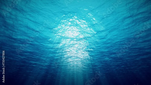 Ocean underwater waves deep blue ripple and flow with light rays. 4K seamless loop	 photo