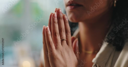 Hands, prayer and woman with faith at her home for worship, religion or spiritual wellness. Gratitude, praying and closeup of female person with christian praise for healing and peace in apartment. photo
