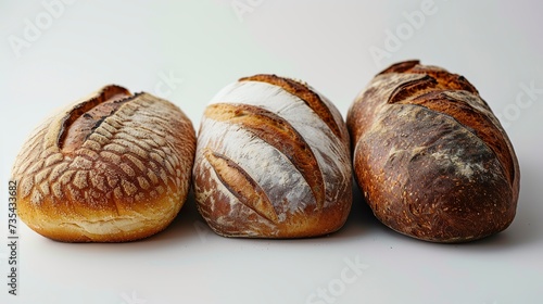 A variety of fresh breads on a white background exuding tempting aromas and inviting delight. Diverse selection of breads ensuring a satisfying tasting experience.