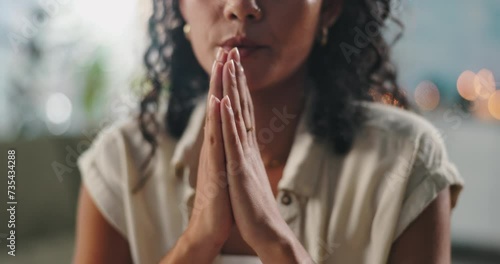 Hands, praying and woman with faith at her home for worship, religion or spiritual wellness. Gratitude, prayer and closeup of female person with christian praise for healing and peace in apartment. photo