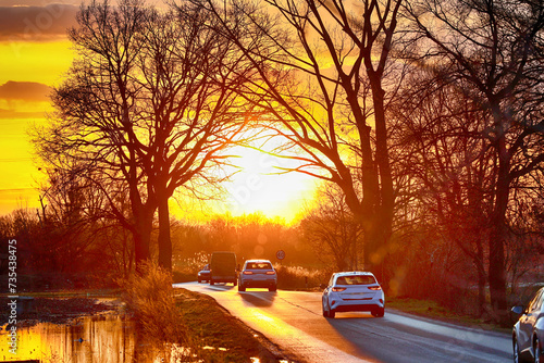 Słoneczna droga z ruchem samochodów. Po słońce.