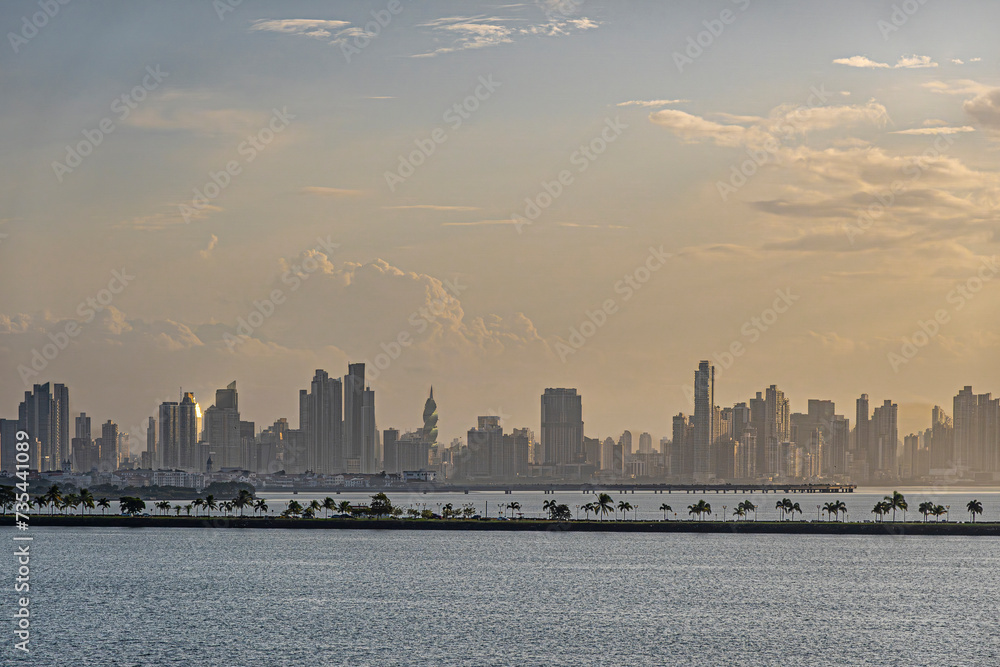 Panama Canal, Panama - July 24, 2023: long Amador Causeway in front of city skyline at entrance to canal, Pacific side under morning sunrise cloudscape. 