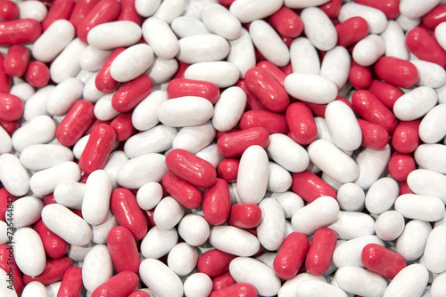 Close up on background of white and pink candy coated licorice treats.