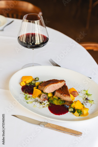 Food photography, delicious duck fillet on a large white plate. Restaurant, banquet, catering.