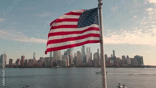 Manhattan, NYC aerial view. American flag in NYC. Memorial Day, Veteran's Day, 4th of July in NYC. American Flag Waving near New York City, Manhattan view. NYC, Manhattan skyline.