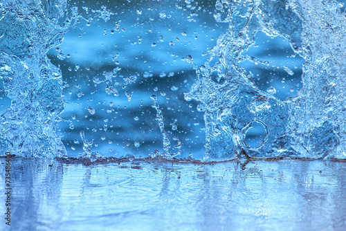 Splash in the water, water droplets, abstract blue background