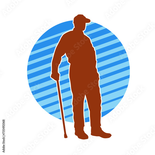 Silhouette of an elderly man standing with walking cane.