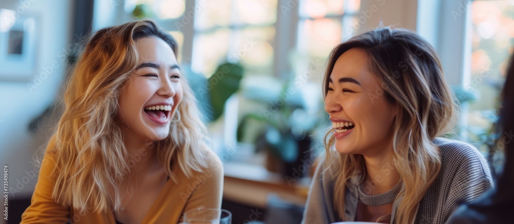 Joyful and animated conversation between two women while laughing and enjoying each other's company