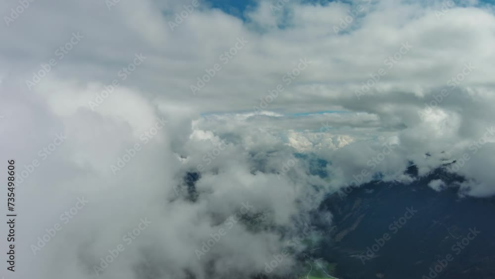 Flying between clouds. Aerial view of snowcapped mountains in clouds, Austrian Alps, Austria, 4k Flying between clouds. Aerial view of snowcapped mountains in clouds, Austrian Alps, Austria, 4k