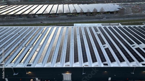 Top view Solar Cell on Warehouse Factory. Solor photo voltaic panels system power or Solar Cell on industrial building roof for producing green ecological electricity. Production of renewable energy.