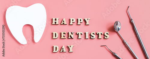 Dental care concept. Dental tools on pink background. Happy dentist day. Paper cut mockup of tooth.