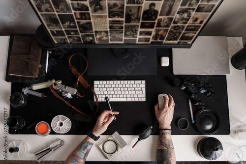 Overhead view of a photographer's desk, showcasing an array of professional photography equipment and tools, reflecting a blend of technology and art photo