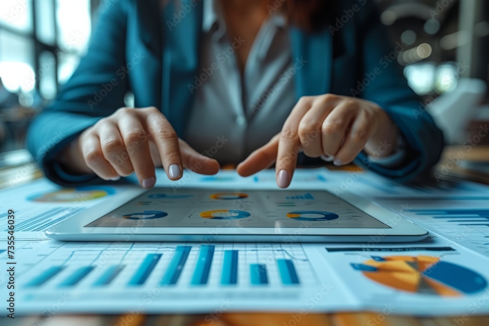 People sitting at tables, looking at charts on tablets, employees looking at charts on tablets People sitting at tables, looking at charts on tablets, employees looking at charts on tablets