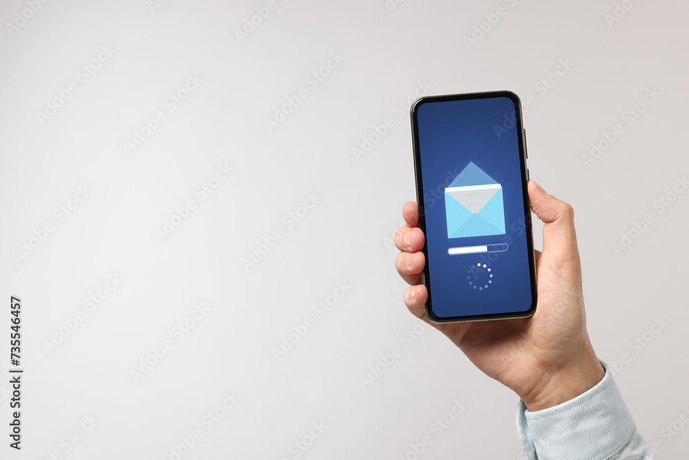 Got new message. Man holding smartphone on light grey background, closeup. Space for text Got new message. Man holding smartphone on light grey background, closeup. Space for text