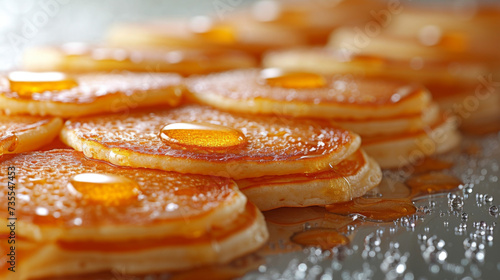 Texture of golden brown pancakes displaying the change from a smooth batter to a fluffy and crispy breakfast dish.