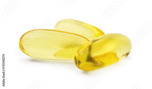 Many yellow vitamin capsules isolated on white