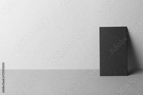 Blank black business card on grey background. Mockup for design