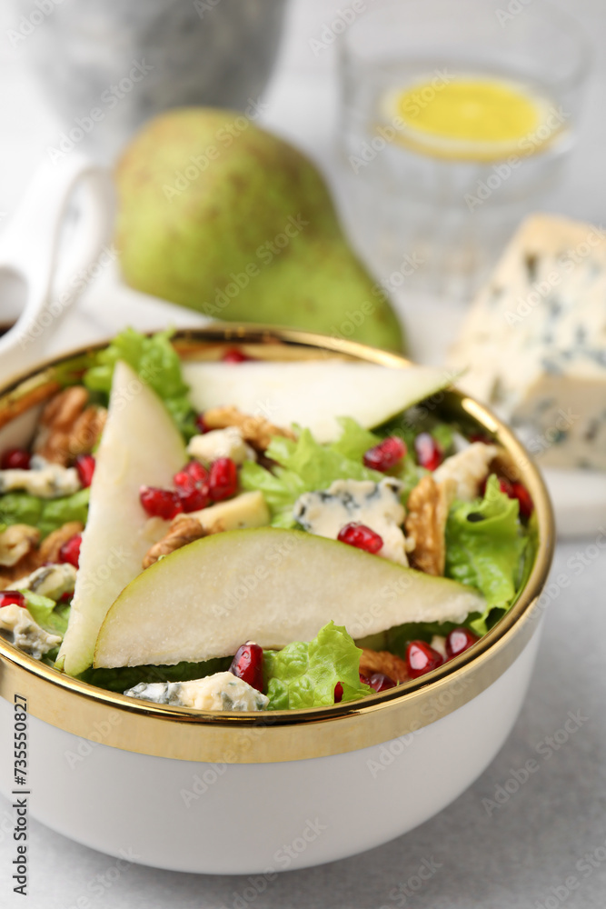 Delicious pear salad in bowl on light table, closeup Delicious pear salad in bowl on light table, closeup