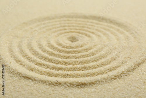 Zen rock garden. Circle pattern on beige sand, closeup