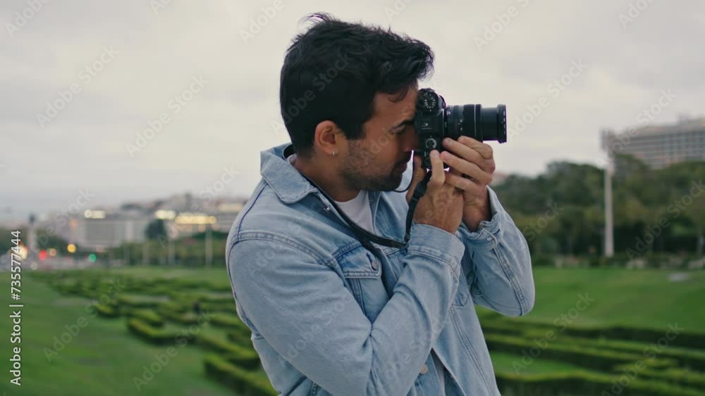 Travel blogger taking picture green park close up. Unshaven man looking photo Travel blogger taking picture green park close up. Unshaven man looking photo
