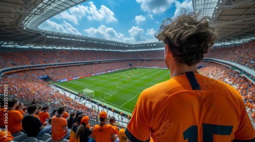 supporters of the Dutch football team in a football stadium, supporters of the Netherlands in a stadium, fans at a soccer game, EK or world cup concept photo