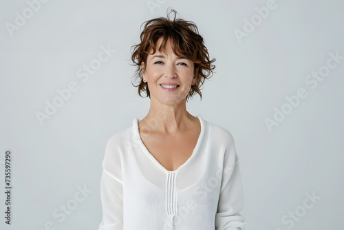 Portrait of happy mid 40s woman wear white sweeter looks in camera isolated on white background